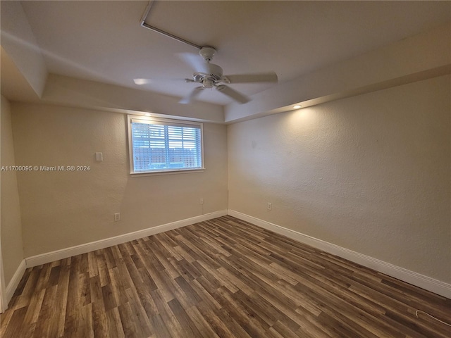 unfurnished room featuring ceiling fan and dark wood-type flooring