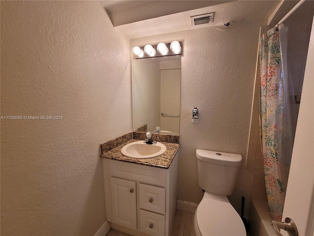 full bathroom featuring vanity, shower / tub combo, and toilet