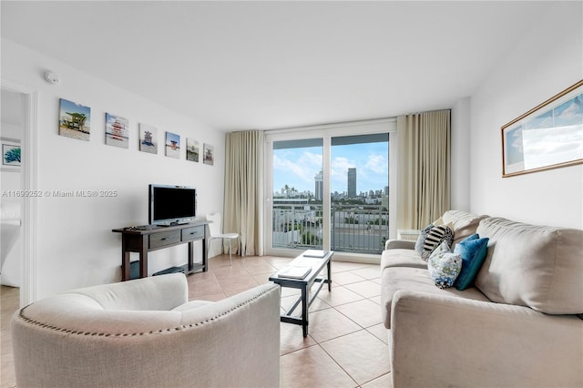 living room with floor to ceiling windows and light tile patterned floors