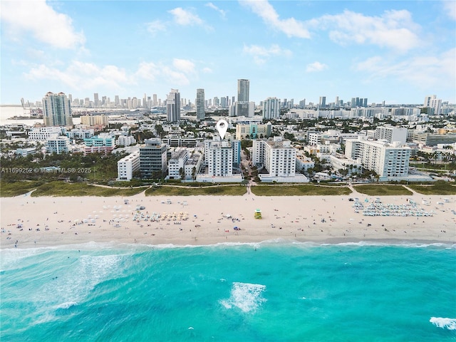 bird's eye view with a city view, a view of the beach, and a water view