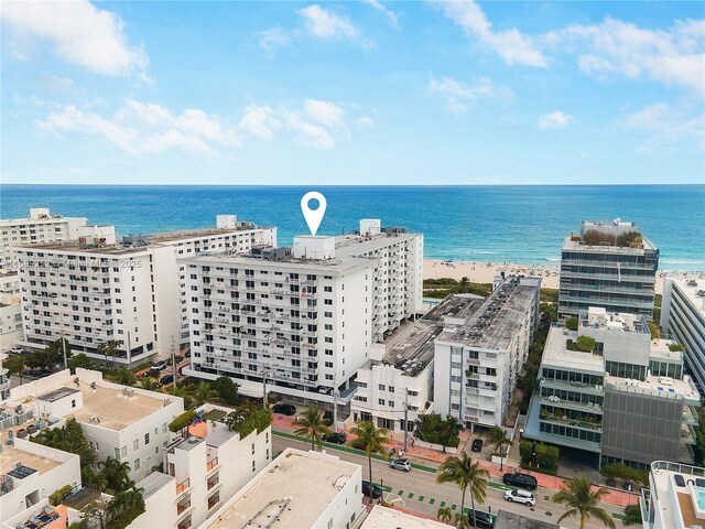 birds eye view of property with a water view and a view of the beach