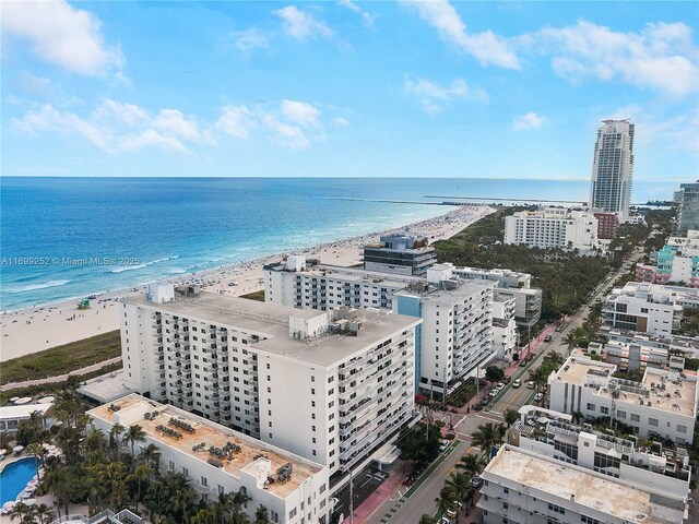 birds eye view of property featuring a beach view and a water view