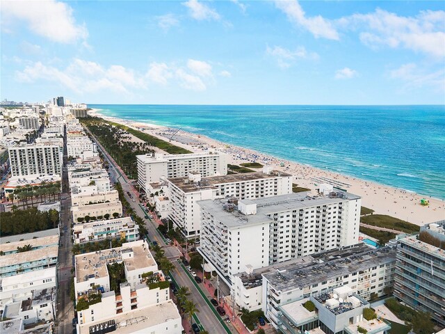 drone / aerial view with a beach view and a water view