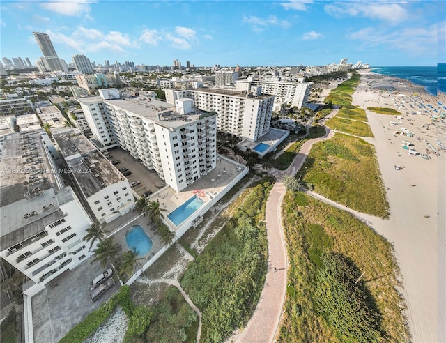 bird's eye view with a water view and a beach view