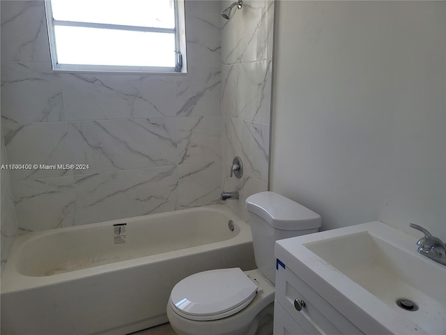 full bathroom featuring toilet, vanity, and tiled shower / bath combo