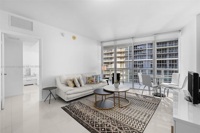 tiled living room with floor to ceiling windows