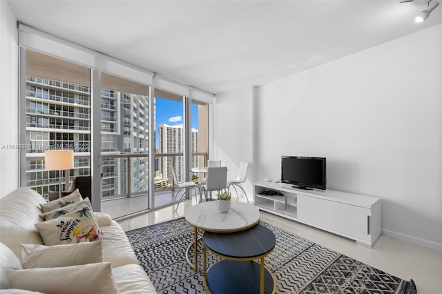 living room with a wall of windows and a healthy amount of sunlight