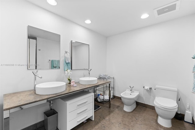 bathroom featuring a bidet, vanity, and toilet