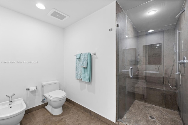 bathroom featuring toilet, a bidet, and walk in shower