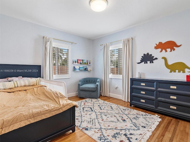 bedroom featuring light hardwood / wood-style floors and multiple windows