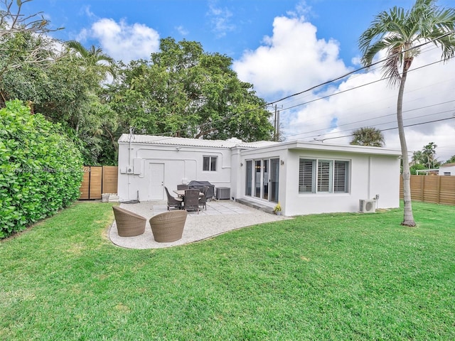 rear view of house featuring central air condition unit, a patio area, a yard, and ac unit