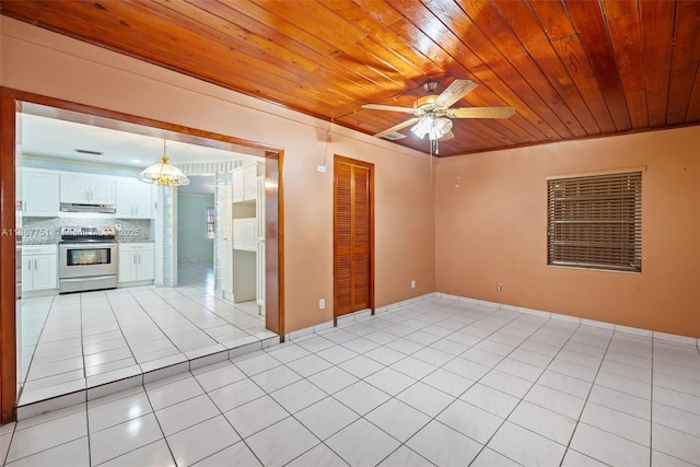 unfurnished room with light tile patterned floors, wooden ceiling, and ceiling fan