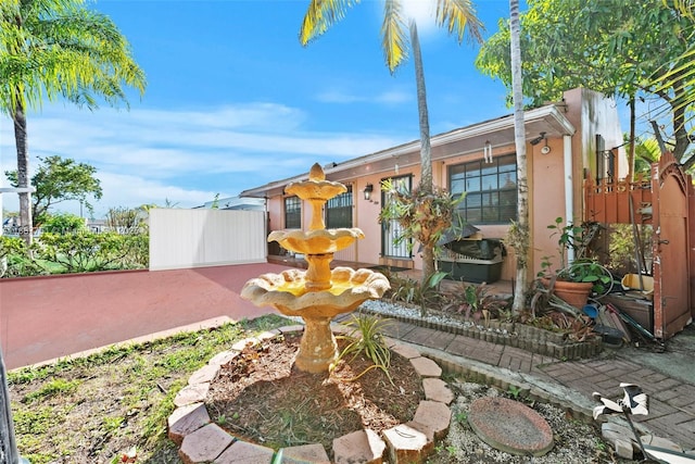 view of front of house with stucco siding and fence