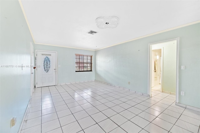 unfurnished room with light tile patterned floors, visible vents, and ornamental molding