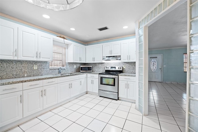 kitchen featuring visible vents, a sink, tasteful backsplash, appliances with stainless steel finishes, and extractor fan