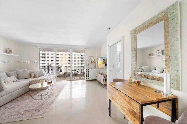 living room with floor to ceiling windows and tile patterned flooring