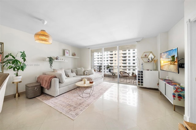 living room with light tile patterned flooring and floor to ceiling windows