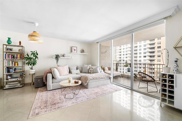 living room featuring light tile patterned floors, floor to ceiling windows, and a healthy amount of sunlight