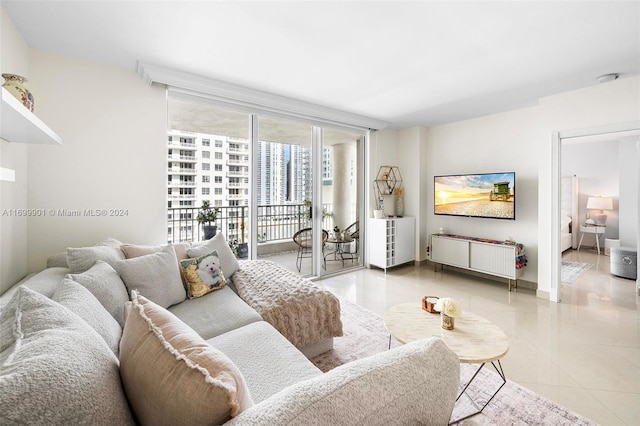 tiled living room featuring floor to ceiling windows