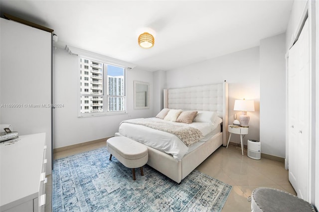 bedroom featuring a closet and light tile patterned floors