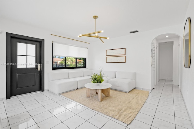 unfurnished living room with a chandelier and light tile patterned floors