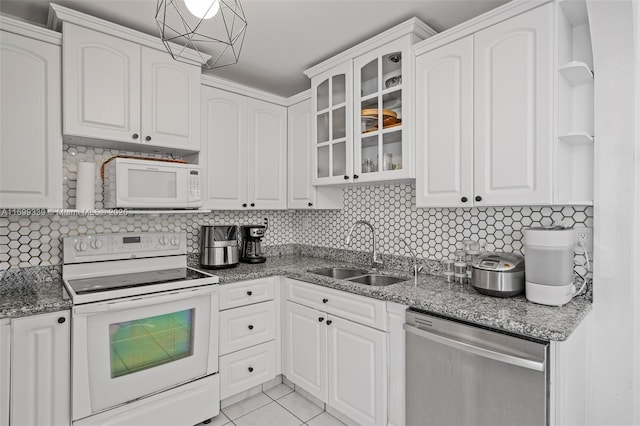 kitchen with white cabinets, white appliances, tasteful backsplash, and sink