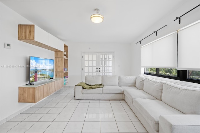 living room with french doors and light tile patterned floors