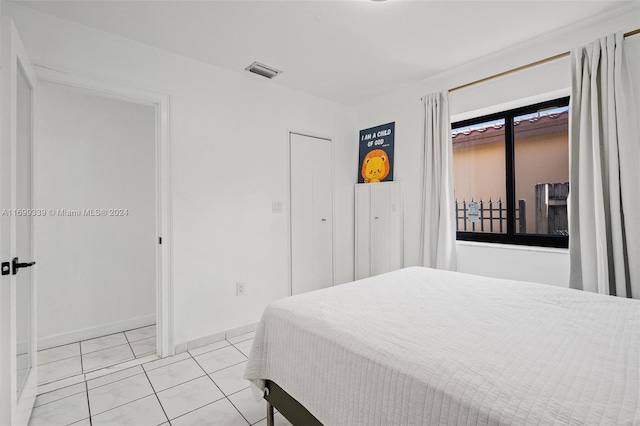 bedroom featuring light tile patterned flooring