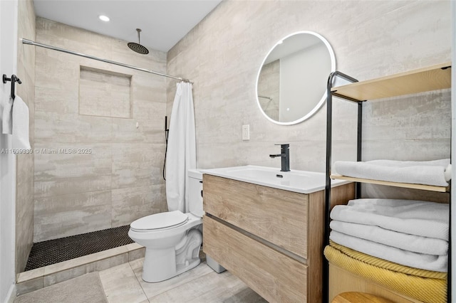 bathroom with a shower with shower curtain, vanity, tile walls, and toilet