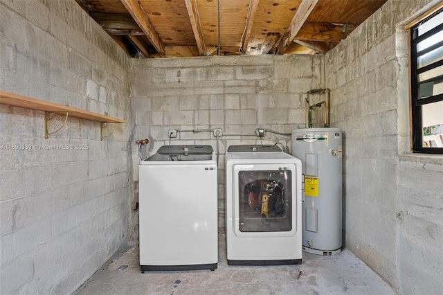 clothes washing area featuring washing machine and clothes dryer and water heater