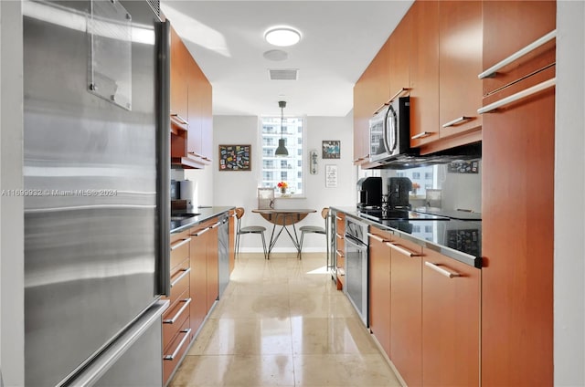 kitchen featuring decorative light fixtures and appliances with stainless steel finishes