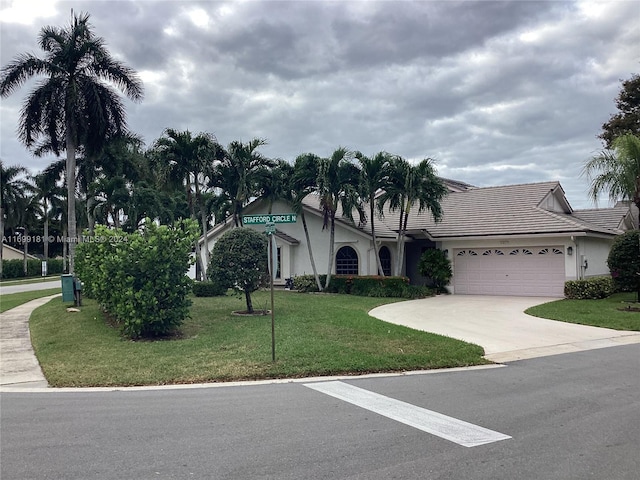 view of front of home with a front yard and a garage