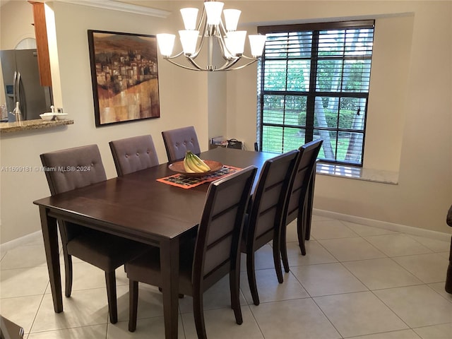 tiled dining space with crown molding and a notable chandelier