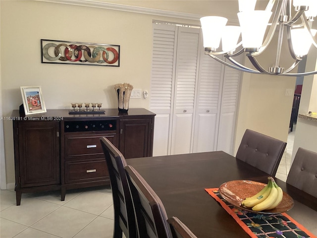 tiled dining space with an inviting chandelier