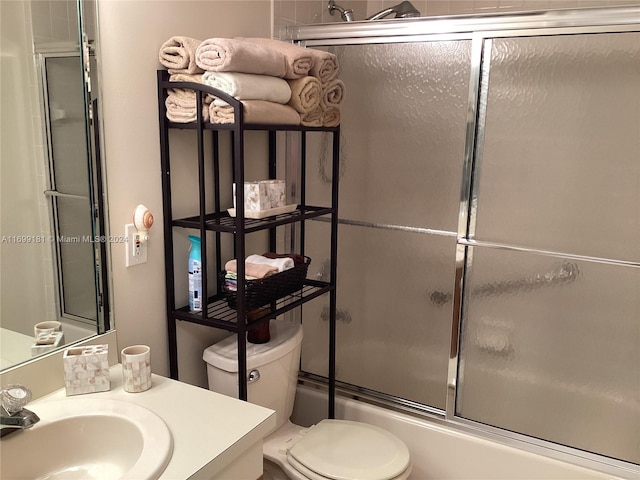 full bathroom featuring toilet, vanity, and combined bath / shower with glass door