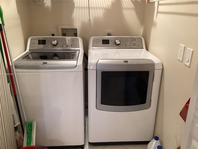 washroom with washer and dryer and light tile patterned flooring