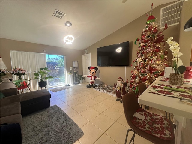 living room with light tile patterned floors and vaulted ceiling