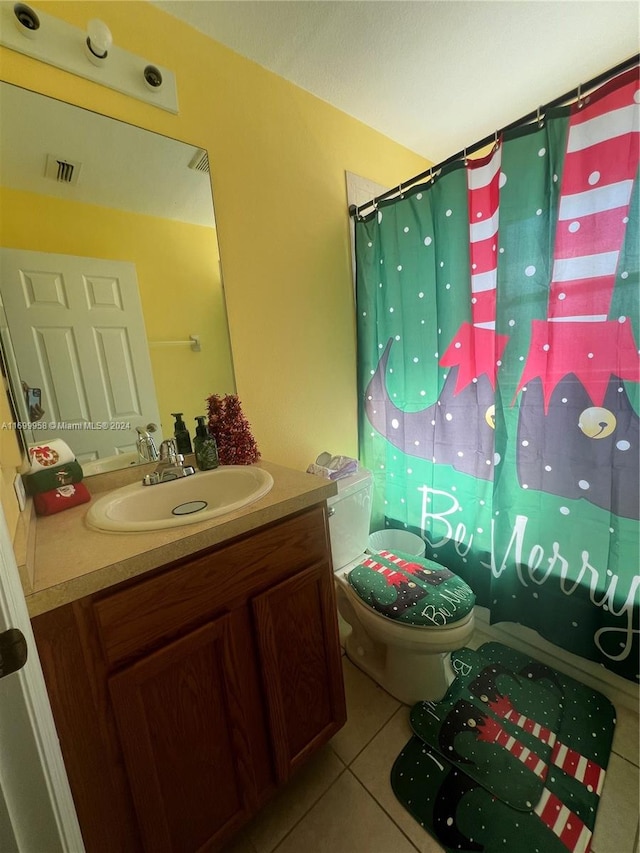 bathroom featuring tile patterned floors, walk in shower, vanity, and toilet