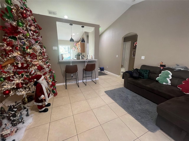 tiled living room featuring lofted ceiling