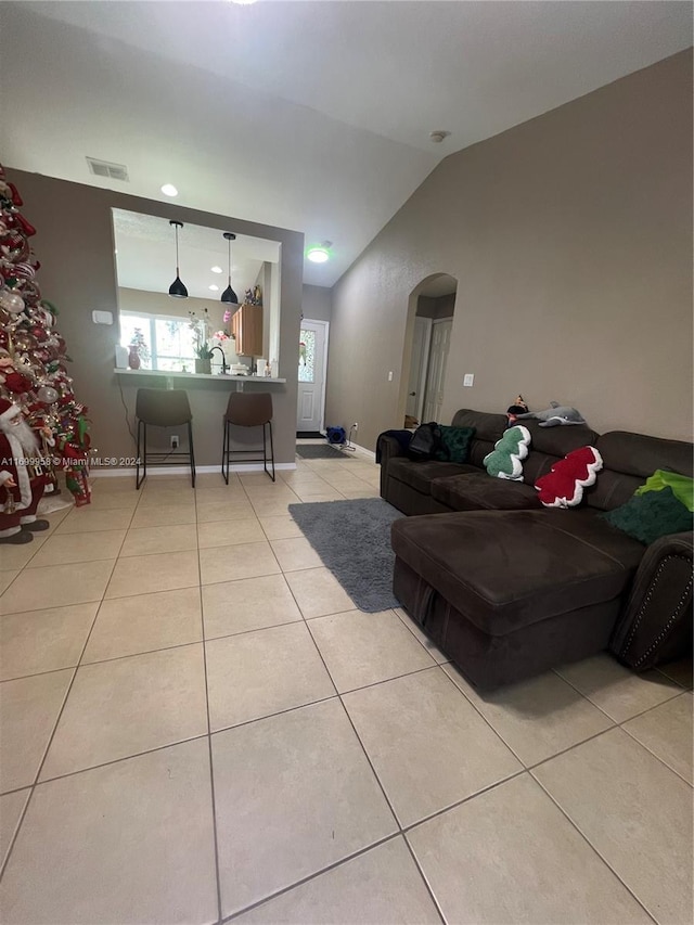 tiled living room with lofted ceiling