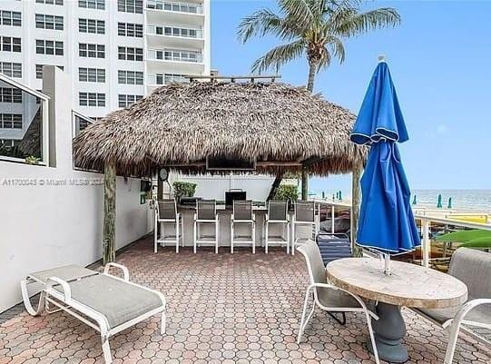 view of patio featuring an outdoor bar