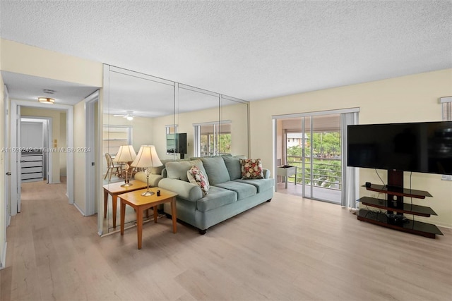 living room featuring light hardwood / wood-style floors and a textured ceiling