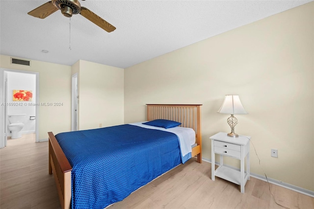 bedroom featuring ceiling fan, ensuite bathroom, and light hardwood / wood-style floors