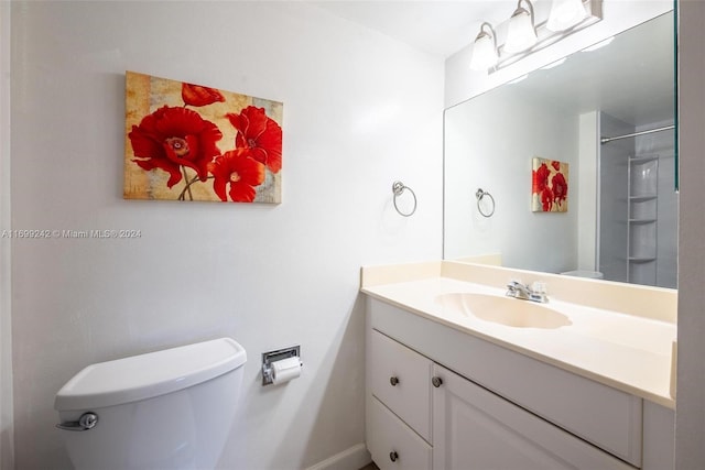 bathroom with a shower, vanity, and toilet