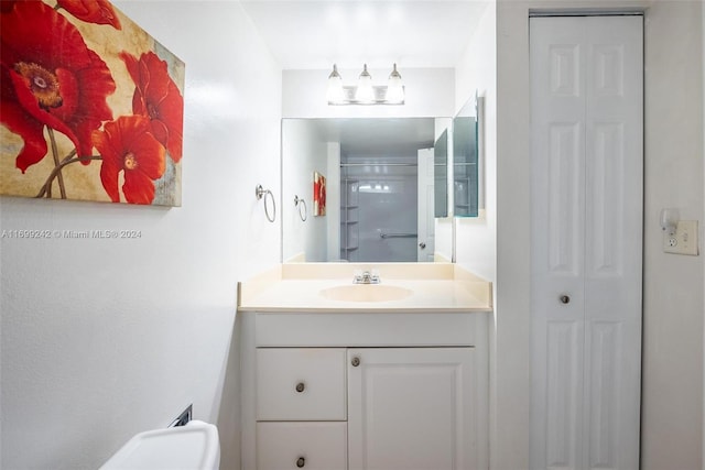 bathroom featuring vanity, a shower with shower door, and toilet