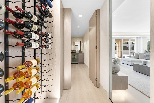 wine area featuring wine cooler and light hardwood / wood-style floors