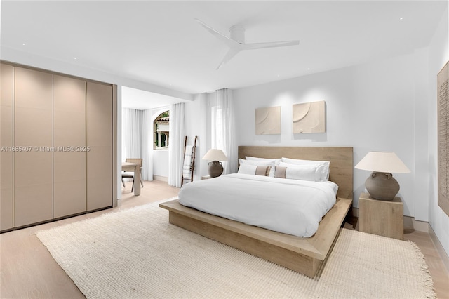 bedroom featuring light wood-type flooring and ceiling fan