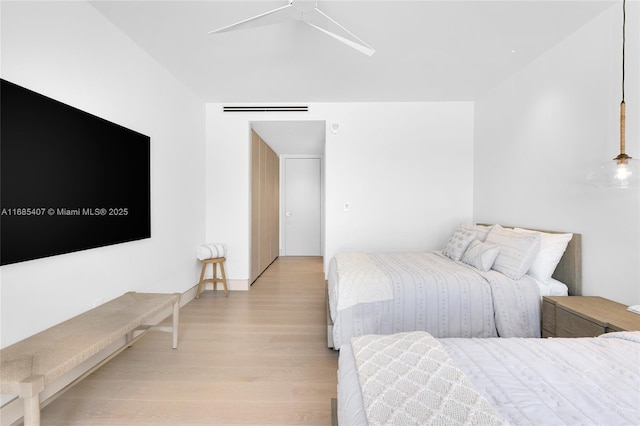 bedroom with ceiling fan and light hardwood / wood-style floors