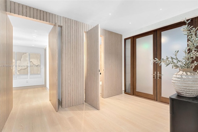 hallway featuring french doors and light hardwood / wood-style flooring