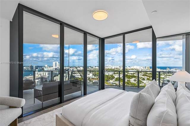 500 Alton Unit 2405/06, Miami Beach, FL 33139 - bedroom featuring a wall of windows, wood finished floors, and a city view